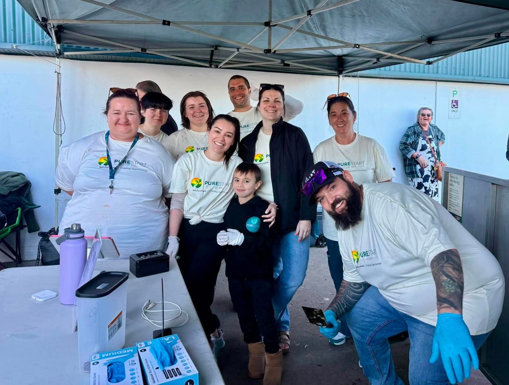 Pure Start team group photo at community event