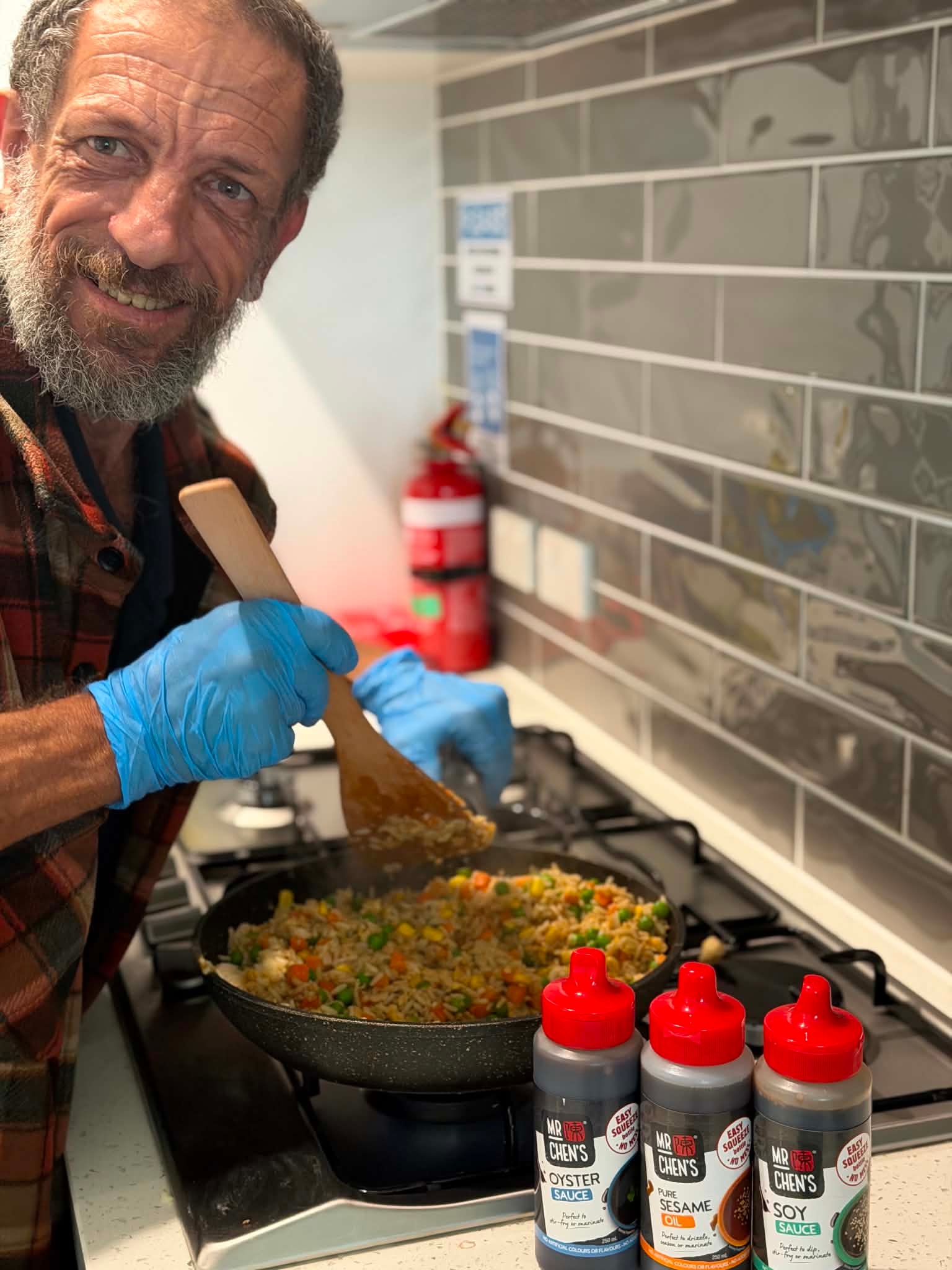 Participant cooking a stir fry at the Skills Hub Eat Well program