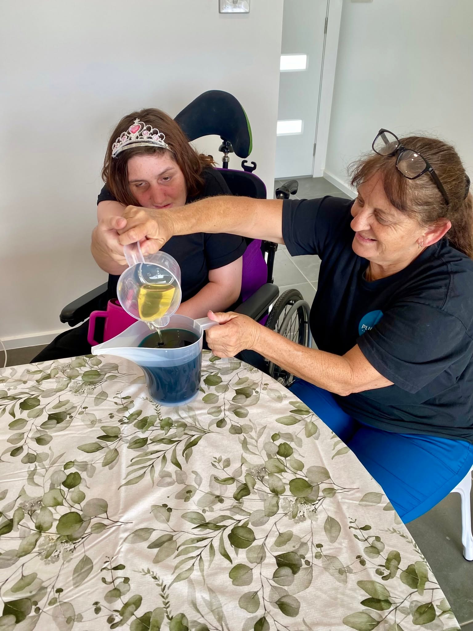 Participant pouring candle wax at the Skills Hub candle making workshop