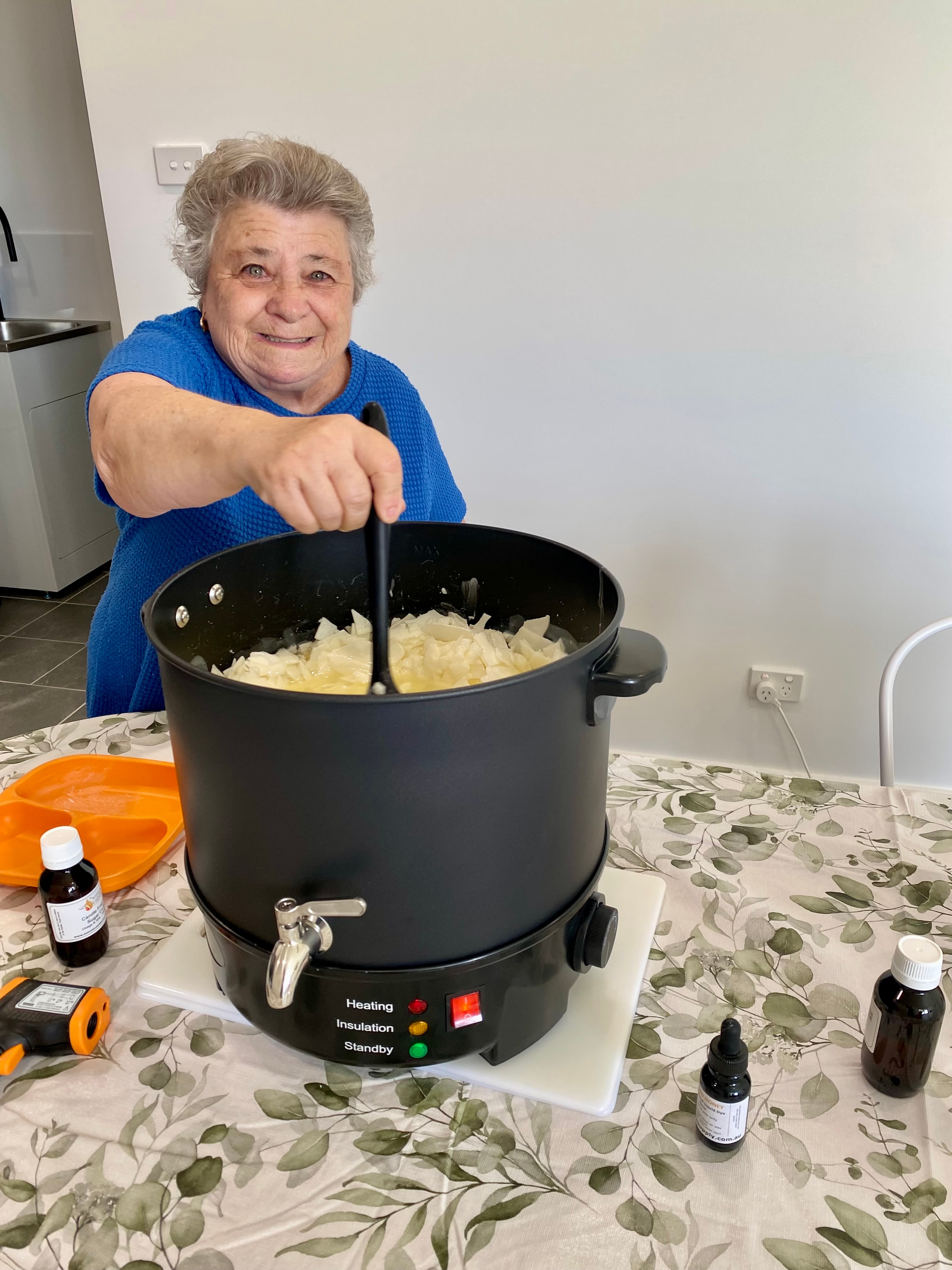 Participant stirring wax at the Skills Hub candle making workshop